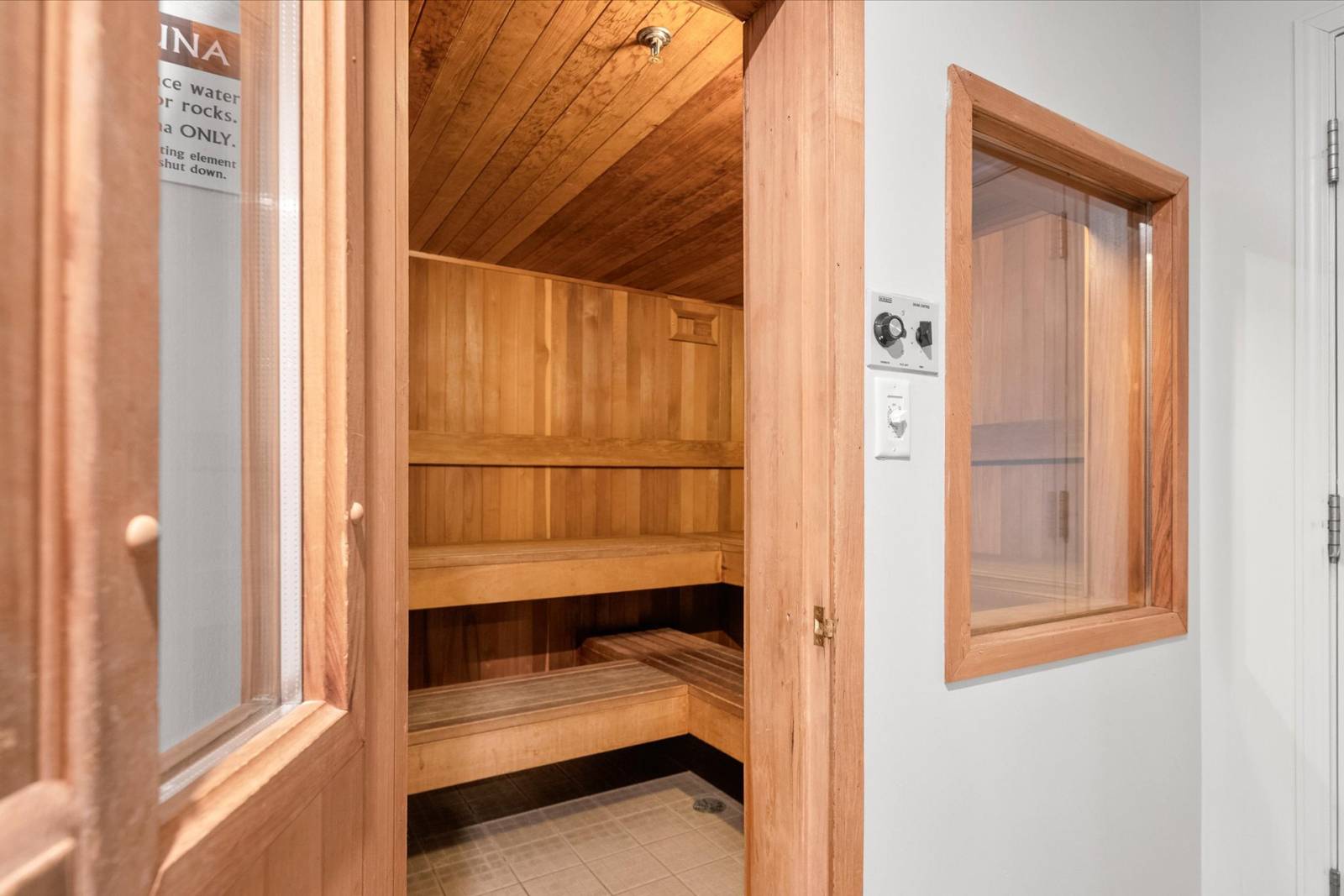 The cedar-lined sauna in the building, with tiered wood benches.